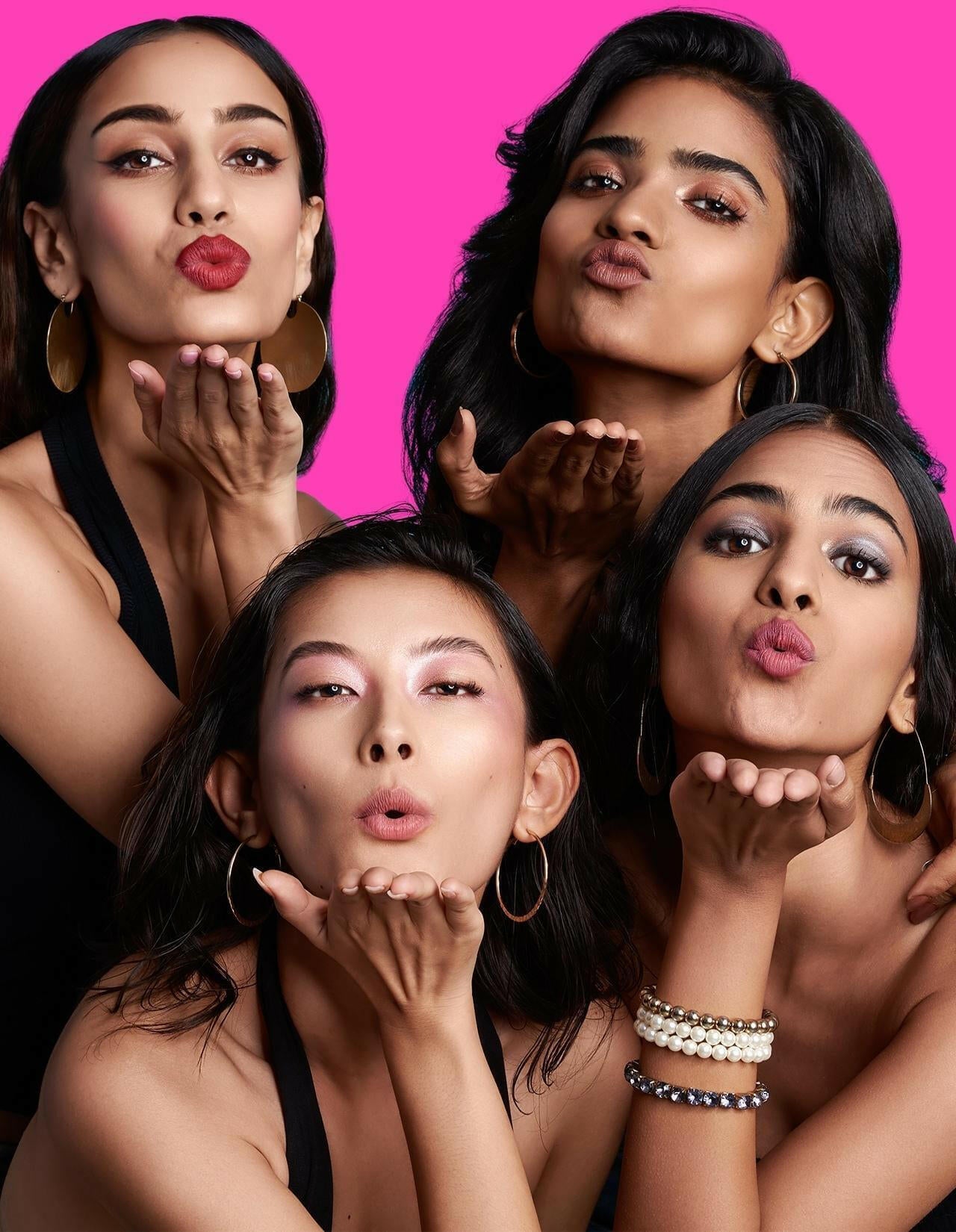 Diverse women showcasing vibrant SOAK IT LIPSTICK with bold poses.